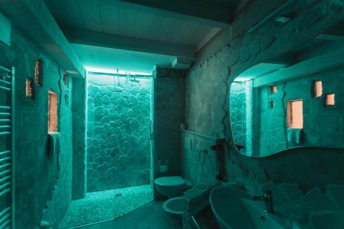 a bathroom with a shower and a sink and a mirror at LUX LUCIS in Matera