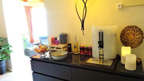 a counter top with bottles of wine and other items on it at Hotel Römerhof in Fusch an der Glocknerstraße