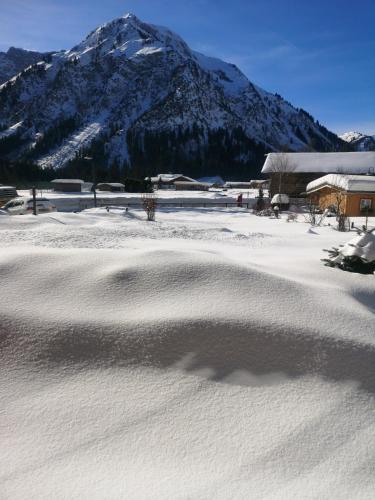 a snow covered field with a mountain in the background at Landhaus Thaler in Mittelberg