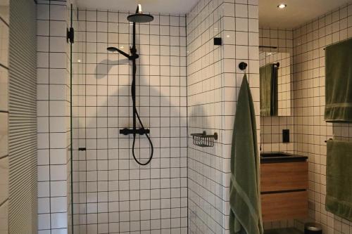 a bathroom with a shower with a shower head at Overnachten in de oude West-Indiëschool in Enschede