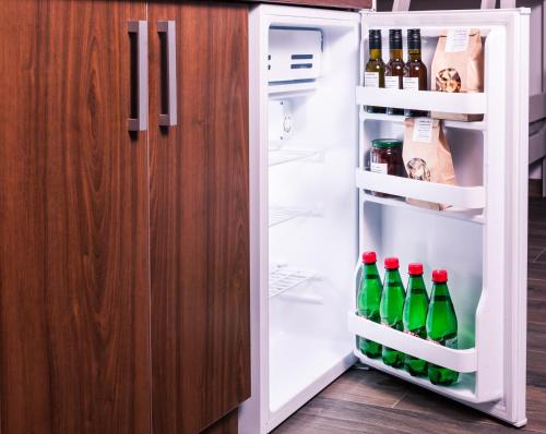 an open refrigerator filled with lots of soda bottles at Hotel Cider&Squash, Grncarska 8, Prnjavor in Batočina