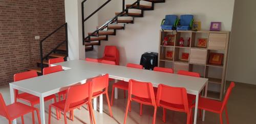 a room with a table and red chairs at Yael Ashalim Solar Home in Ashalim