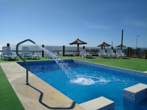 a swimming pool with a water fountain at Complejo San Cristobal in Santa Clara del Mar