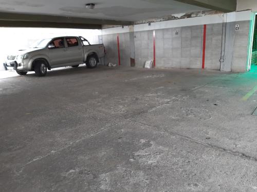 a gray truck parked in a parking garage at Hotel Garden in San Miguel de Tucumán