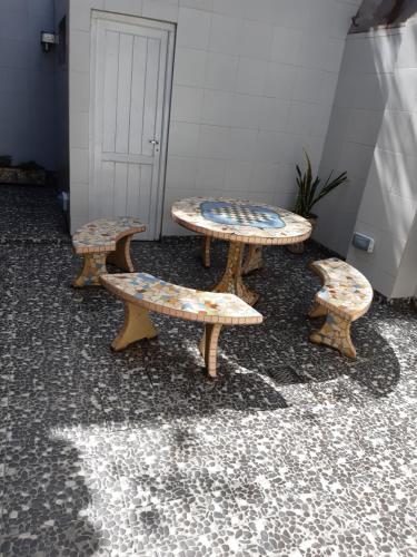 a group of three benches sitting in a room at Hotel Garden in San Miguel de Tucumán