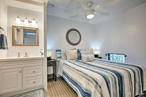 a bedroom with a bed and a sink and a mirror at Stunning Makaha Condo with Pool Access and Ocean View! in Waianae