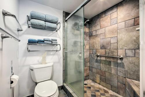 a bathroom with a toilet and a glass shower at Stunning Makaha Condo with Pool Access and Ocean View! in Waianae