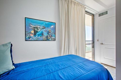 a bedroom with a blue bed and a window at Stunning Makaha Condo with Pool Access and Ocean View! in Waianae
