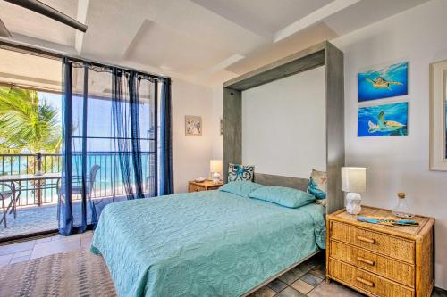 a bedroom with a bed and a view of the ocean at Stunning Makaha Condo with Pool Access and Ocean View! in Waianae
