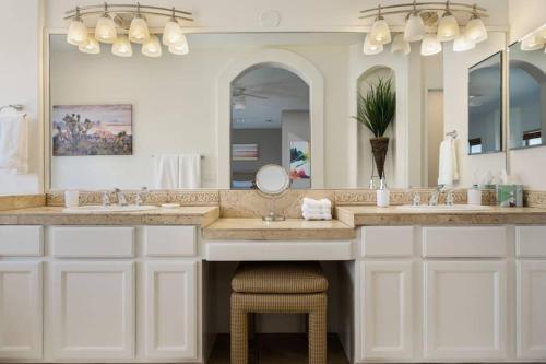 a bathroom with two sinks and a large mirror at The Playa in Indio