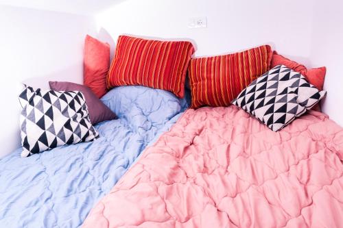 a bed with pillows on top of it at Hotel Cider&Squash, Grncarska 8, Prnjavor in Batočina