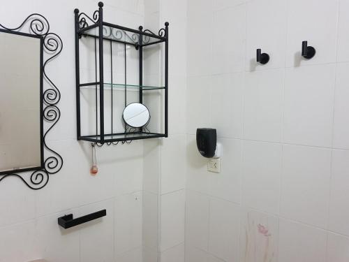 a mirror on the wall of a bathroom at APARTAMENTO LOS BÚHOS in Murcia