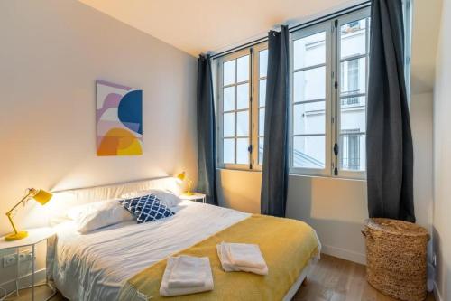 Ліжко або ліжка в номері Lofts Philippe-Auguste