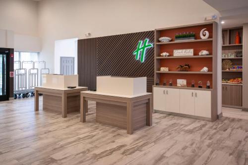 a room with two desks in a store at Holiday Inn Pensacola - University Area by IHG in Pensacola