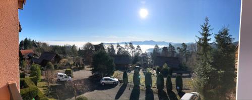 a view of a house with cars parked in a driveway at Trois-Épis, vue magnifique in Ammerschwihr