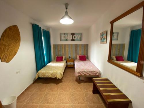 a room with two beds and a mirror at CASA CANDELARIA,PARKING,AIR,WIFi in Candelaria