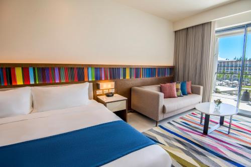 a hotel room with a bed and a couch at Hyatt Zilara Cap Cana - Adults Only in Punta Cana