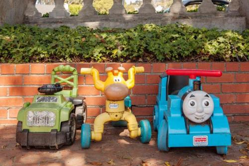 two toy cars parked next to a brick wall at Large 1 Bedroom Apartment, Home Theater, Fireplace in Berkeley