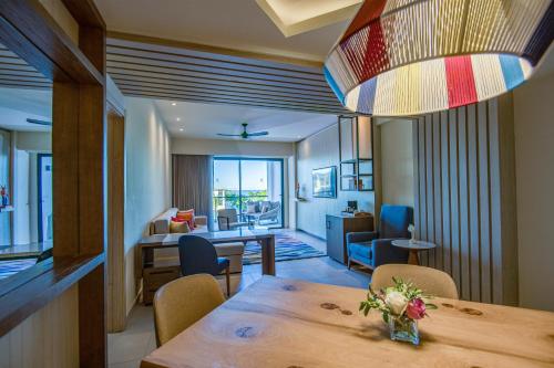 a dining room with a table and a living room at Hyatt Zilara Cap Cana - Adults Only in Punta Cana