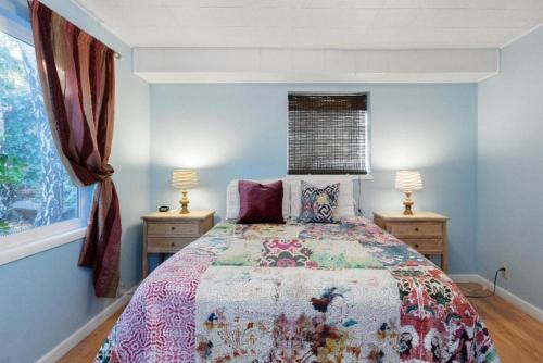 a bedroom with a bed and two night stands at Large 1 Bedroom Apartment, Home Theater, Fireplace in Berkeley