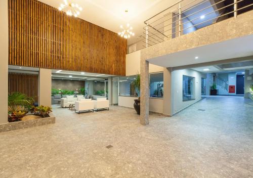 an empty lobby with couches and tables in a building at Pousada Castellammare in Bombinhas