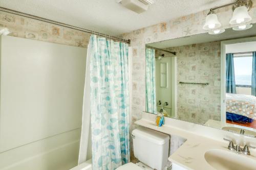 a bathroom with a sink and a toilet and a mirror at Cloud 9 on the Ocean in Myrtle Beach