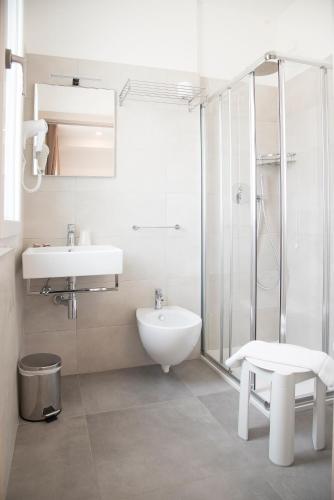 a bathroom with a sink and a toilet and a shower at Hotel Solemare - Frontemare - 3 Stelle Superior in Lido di Jesolo