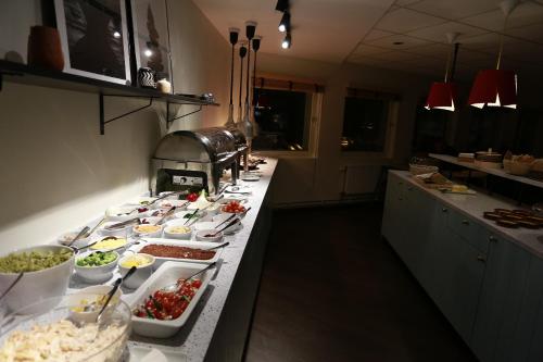 a buffet line with many dishes of food on it at Good Morning Arlanda in Arlanda