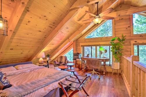 a bedroom in a log cabin with a bed and a desk at Luxury Mountain Cabin with Furnished Deck and Views! in Loma Linda