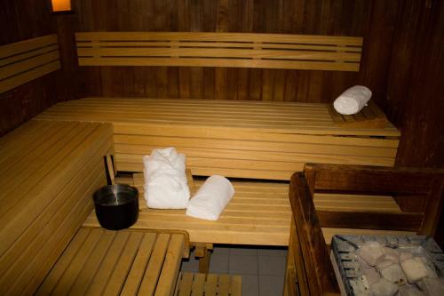 a sauna with two beds and two white towels at Ara Hotel Comfort in Ingolstadt