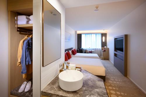 a hotel room with a bed and a sink in a room at ibis Melbourne Central in Melbourne
