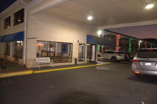 a car parked in a parking lot next to a building at Bestway Inn in Rock Hill