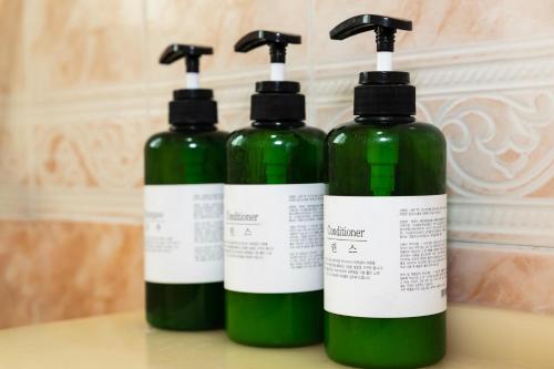 a couple of green bottles sitting on a counter at Hooni Guest House & Motel in Gurye