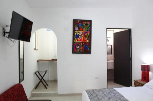 a hotel room with a bed and a mirror at Hotel Casona Margot in Valladolid