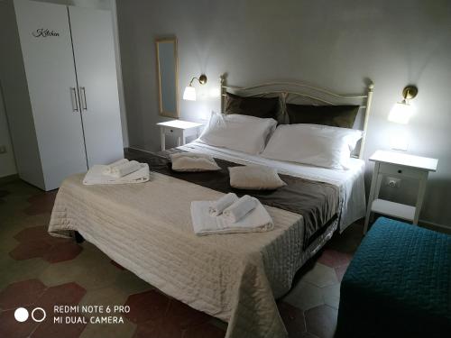 a hotel room with a bed with towels on it at Le Suite del Teatro cucinino privato in Taranto