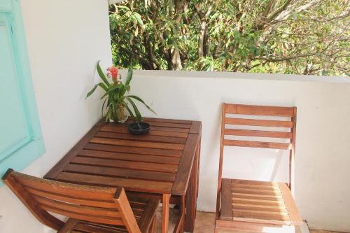a wooden table and chairs with a potted plant at Beach Aqualina Apartments in Fort Lauderdale