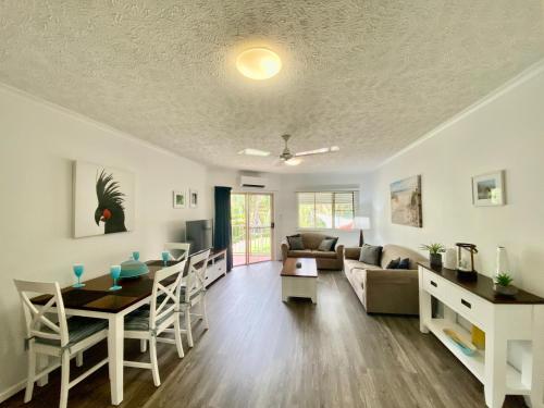 a living room with a couch and a table at Cairns Beach Resort in Cairns