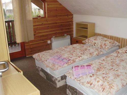 a room with two beds in a room at Apartmány u Jitky in Zlín