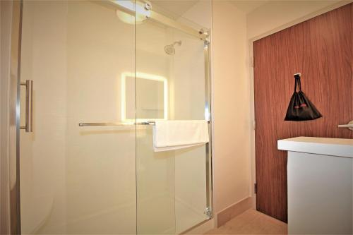 a shower with a glass door in a bathroom at Holiday Inn Express & Suites Ocala, an IHG Hotel in Ocala