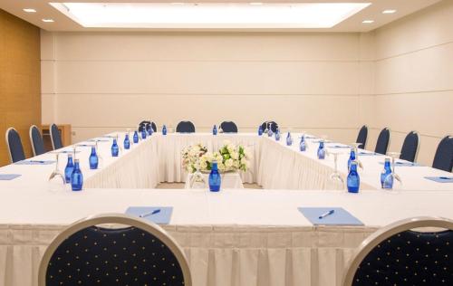a long table in a room with blue bottles on it at Astir Odysseus Kos Resort and Spa in Tigaki