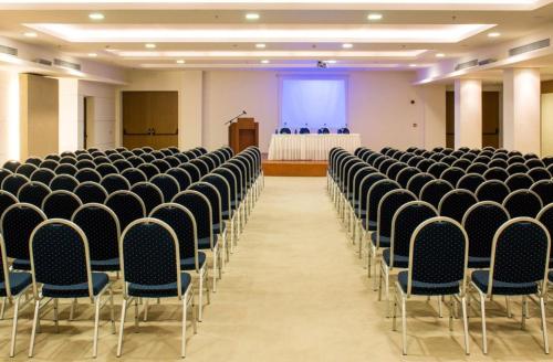 an empty room with chairs and a podium in the background at Astir Odysseus Kos Resort and Spa in Tigaki