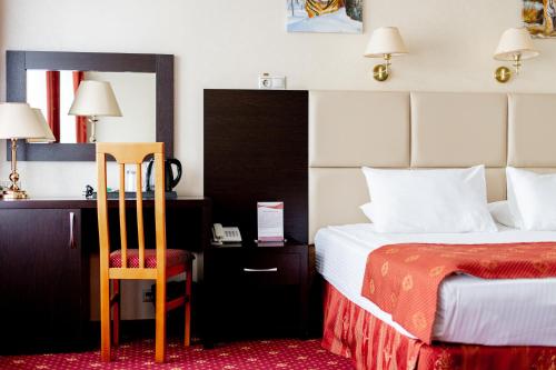Кровать или кровати в номере АМАКС Сити Отель