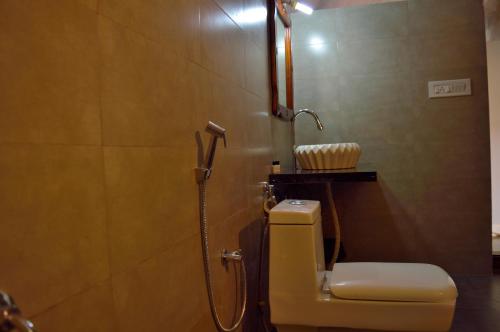 a bathroom with a shower and a toilet in it at Thour Nature Resort - Jawai Leopard Safari Camp in Bera