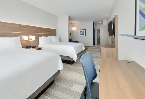 a hotel room with two beds and a desk at Holiday Inn Express & Suites - Plano - The Colony by IHG in The Colony