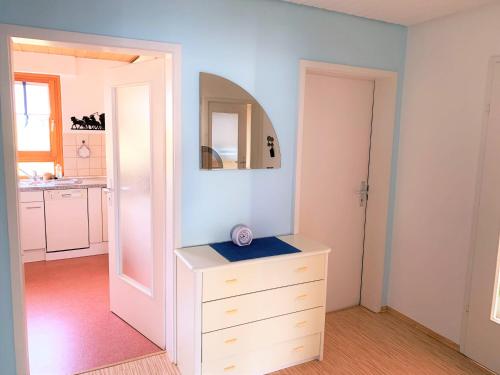 a bedroom with a dresser and a mirror at BodenSEE Apartment Friedrichshafen Manzell in Friedrichshafen