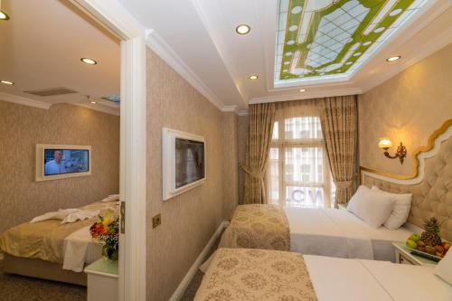 a bedroom with two beds and a window at Alpek Hotel in Istanbul