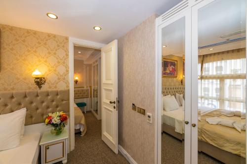 a hotel room with a bed and a mirror at Alpek Hotel in Istanbul