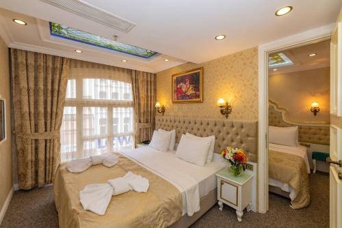 a bedroom with a large bed and a window at Alpek Hotel in Istanbul