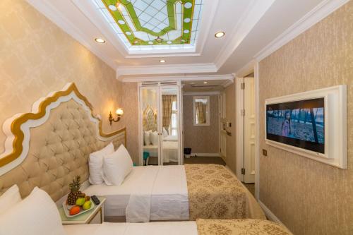 a bedroom with a large bed and a skylight at Alpek Hotel in Istanbul