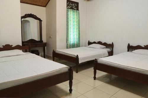 Cama o camas de una habitación en Sunarta House Homestay